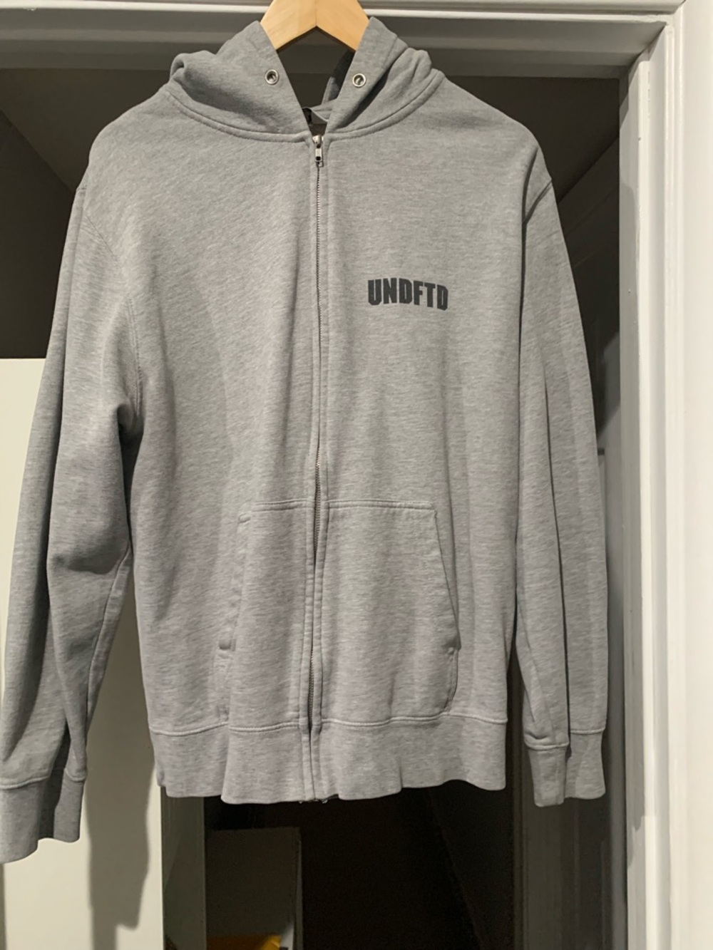 Undefeated Light Grey Zip Hoodie with Logo Tag